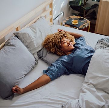 Beautiful Cheerful Woman Having a Lazy Weekend in Bed beautiful cheerful woman having a lazy weekend in bed