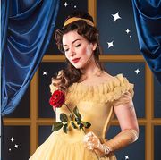 a woman dressed in belle's yellow dress from beauty and the beast and rosie the riveter