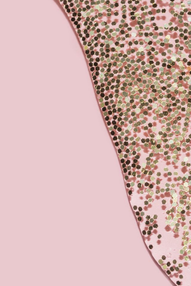 transparent liquid with gold glitter pouring over a pastel pink background transparent liquid with gold glitter pouring over a pastel pink background festive backdrop for your project
