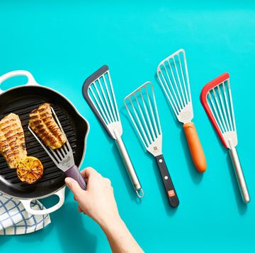 hand lifting grilled fish from a pan next to our top performers