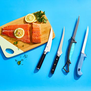 best fish fillet knives shown with salmon, lemon and herbs