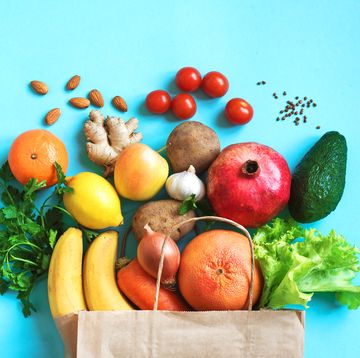 healthy food background healthy vegan vegetarian food in paper bag vegetables and fruits on blue, copy space, banner shopping food supermarket and clean vegan eating concept