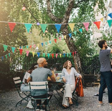 happy multi ethnic friends in backyard during garden party