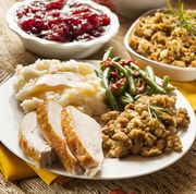 fully cooked thanksgiving dinner with mashes potatoes, stuffing, green beans, and sliced turkey breast