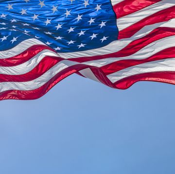 red white and blue american flag blowing in the wind