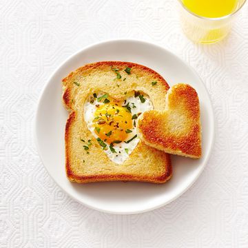 heart toast with egg in the middle on a white plate