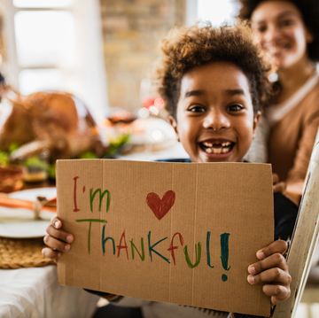 little boy holding i'm thankful sign
