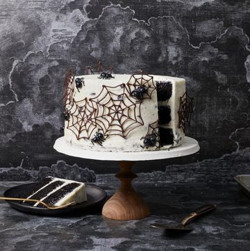 Spiderweb Cake chocolate cake with white frosting, decorated with chocolate spider webs and spiders