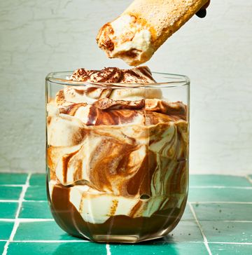 tiramisu dip in a glass on a green tile surface