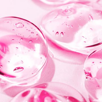 Transparent pink moisture face serum smeared. Hydrating hyaluronic acid. Hair gel with bubbles. Cosmetic products for makeup and skin care. Cosmetology. transparent pink moisture face serum smeared hydrating hyaluronic acid hair gel with bubbles cosmetic products for makeup and skin care cosmetology