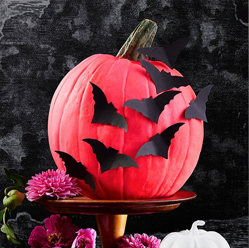diy halloween decorations, bat pumpkin and a gravestone chair cover diy halloween decorations, pink pumpkin with bat designs and a tombstone chair cover