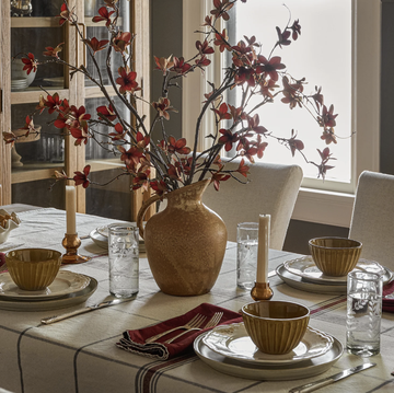joanna gaines magnolia fall collection joanna gaines magnolia fall collection, dining room with a vase of faux flowers, red napkins and neutral toned plates